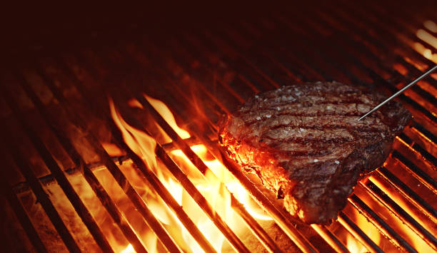 checking internal temp - rib-eye steak on a bbq - meat steak veal beef imagens e fotografias de stock