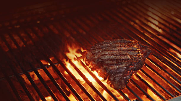 istock Cooking rib-eye steak on a grill 1452549140