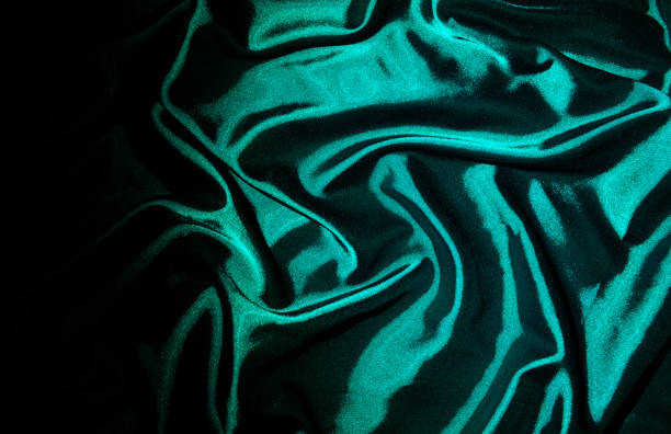 istock Satin silk fabric background, luxury texture. Green. 1452549325