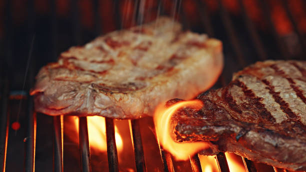 istock Rib-eye steak on very hot grill 1452549582
