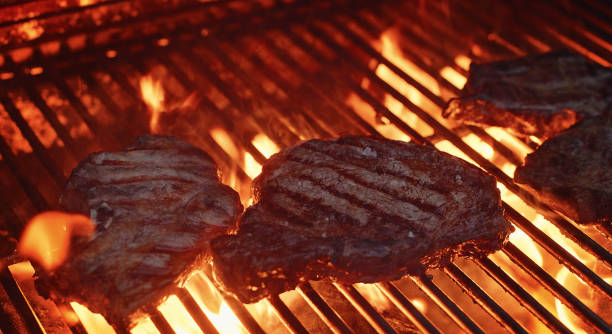 istock Steaks on a barbecue heavy fire 1452550261