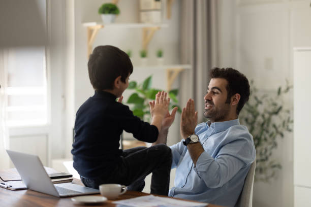 istock Father playing with sons at home 1452550634