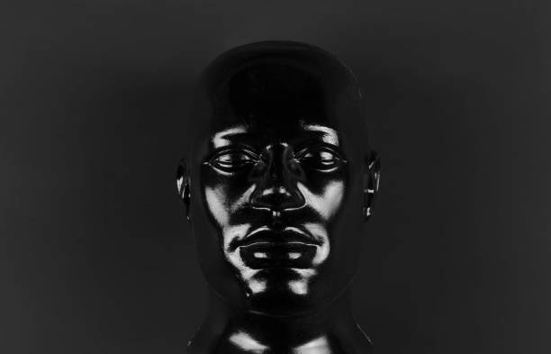 black mannequin head isolated on black background