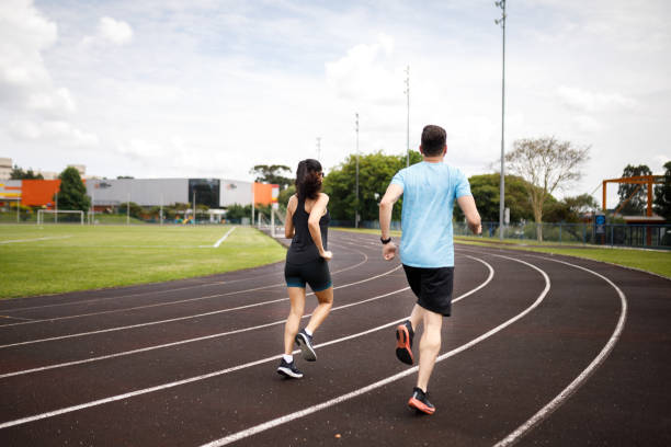 istock Man and woman running on the field 1452554124