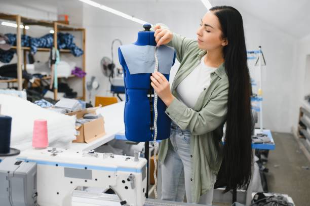 istock Beautiful young woman sewing clothes with sewing machine. 1452554322