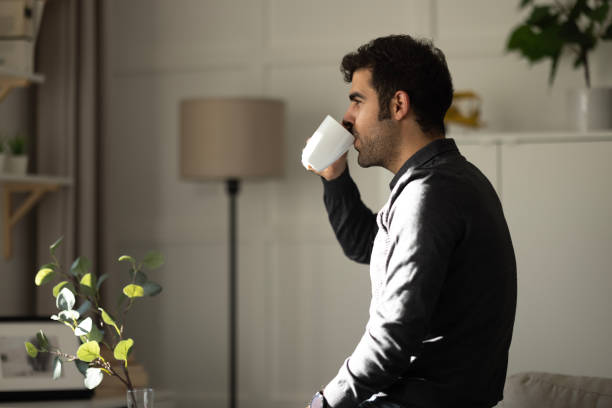 istock Young businessman relaxing on comfortable with cup of coffee. 1452554382