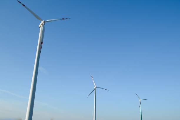 istock Wind Turbines in a Green Field and Blue Sky. 1452555344