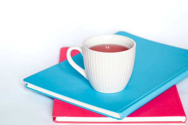 istock A cup of tea and notebooks on a white background, isolated, copy space. 1452556091