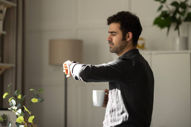 istock Young businessman relaxing on comfortable with cup of coffee. 1452556305