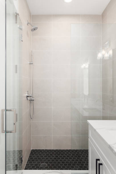 istock A brown tiled shower and black hexagon floor. 1452560565