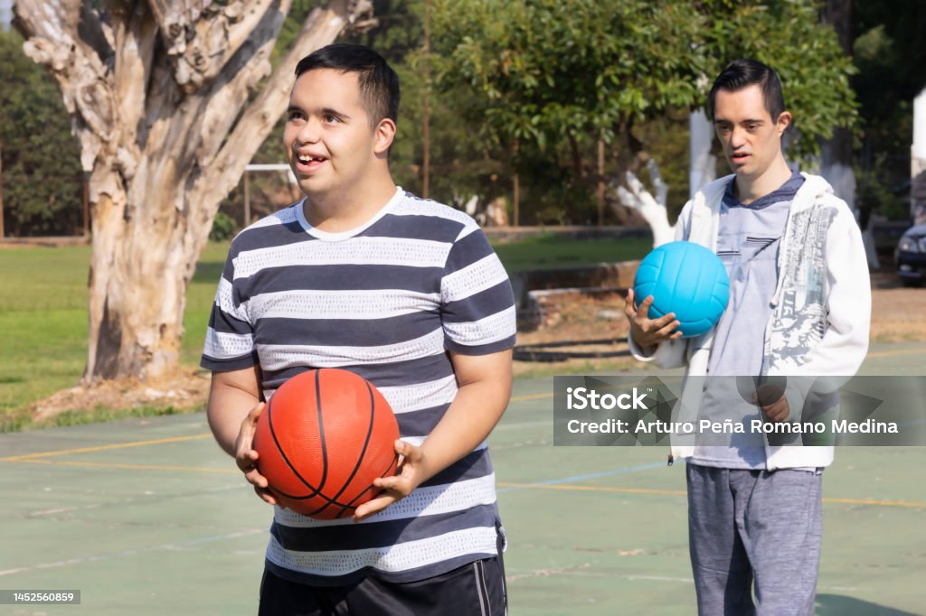 young man with down syndrome with a basketball ready to dunk Down Syndrome Stock Photo