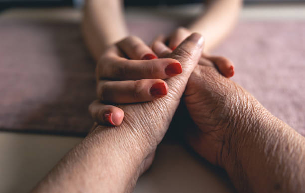 istock Old and young man holding hands, close up. 1452561388