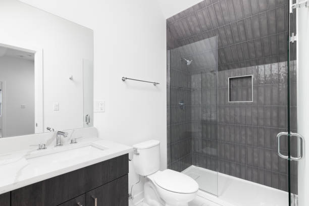 istock A modern bathroom with a grey cabinet and dark grey tiled subway tile shower. 1452561391