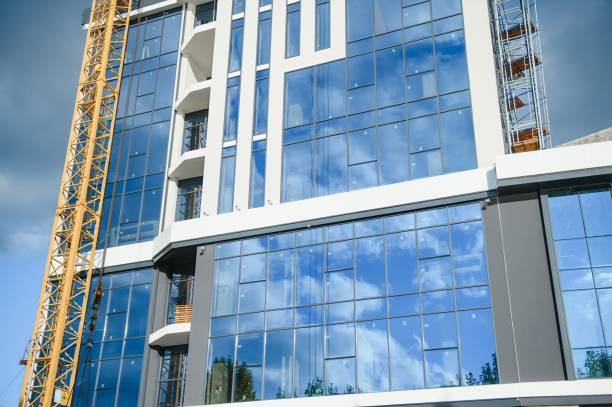 istock Construction cranes are standing near building houses 1452561405