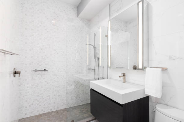istock A bathroom with a wood cabinet and marble tiled shower. 1452561455
