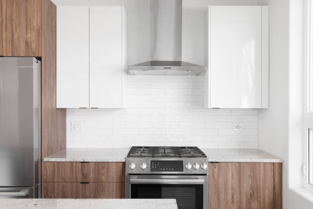 istock A kitchen detail with wood and white cabinets and a subway tile backsplash. 1452561613