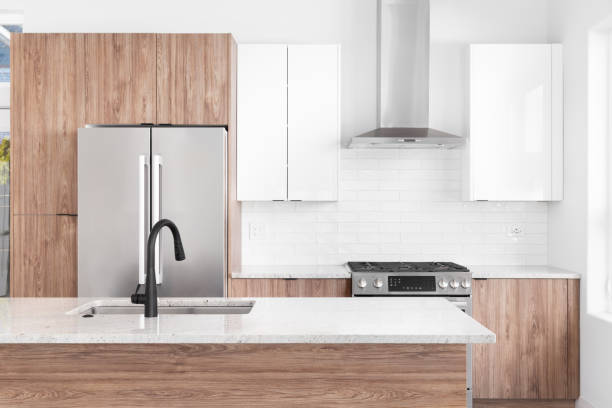 istock A kitchen detail with wood and white cabinets and a subway tile backsplash. 1452562165