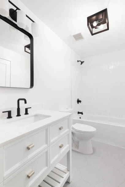 istock A white bathroom with a grey hexagon tile floor. 1452562258