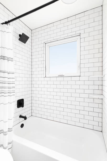 istock A shower with white subway tiles and black showerhead. 1452562277