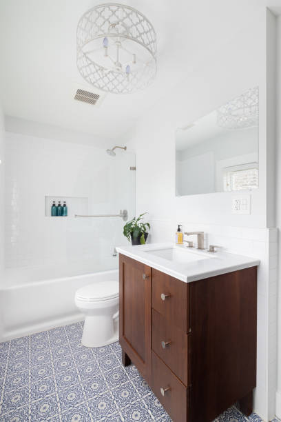 istock A bathroom with a wood vanity and a mosaic tile flooring. 1452562292