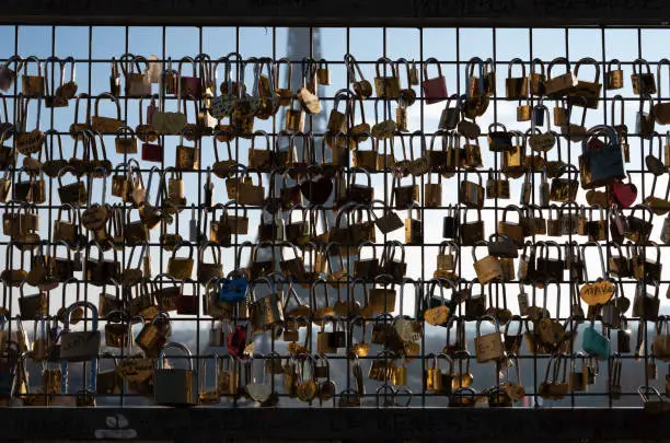 Eiffel Tower seen through a fence covered with padlocks in Trocadero