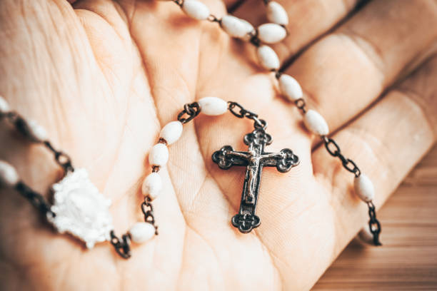 istock Hand with rosary, Catholic faith and prayer concept 1452563573