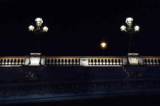Pont Alexandre III in Paris by night seen from a houseboat