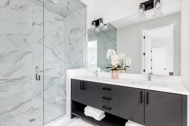 istock A modern bathroom with a grey cabinet and marble tiled shower. 1452564480