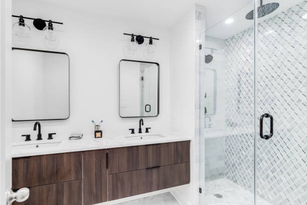 istock A modern bathroom with a brown cabinet and a marble tiled shower. 1452564487