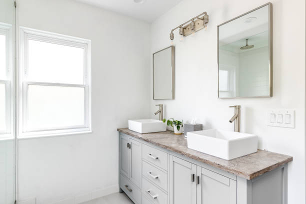 istock A bathroom with a grey cabinet and granite countertop. 1452564496