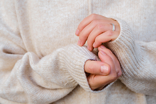 Close-up of female hands. Hand care in cold winter