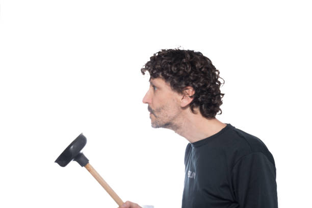 istock Middle-aged man with a flapper to unclog a pipe, isolated on white background. 1452566775