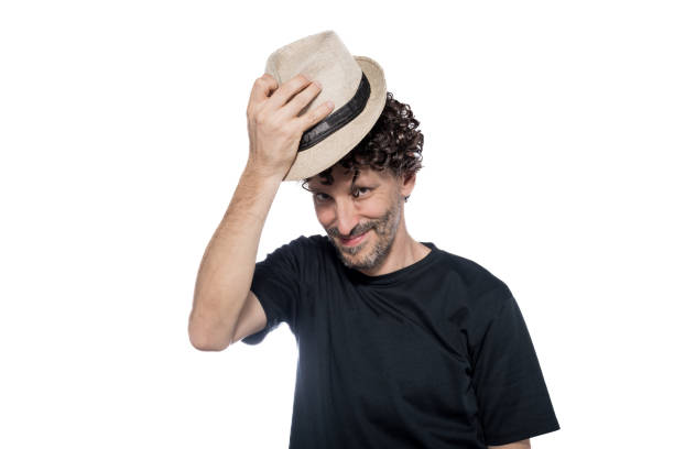 Middle-aged man waving with hat, isolated on white background.