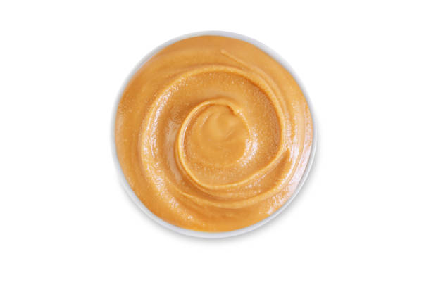 istock Peanut butter in a bowl on a white isolated background 1452566849