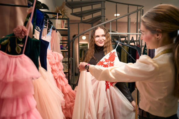 istock Fashion designer selects a beautiful dress for a beautiful client 1452566873