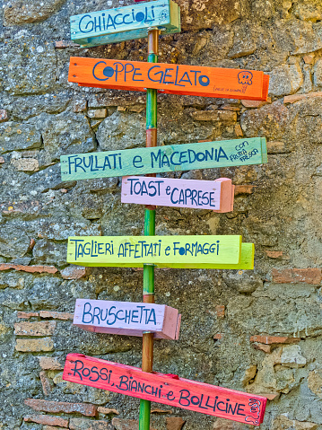 Funky restaurant menu sign found along the streets in the Tuscany town of Volterra in Italy