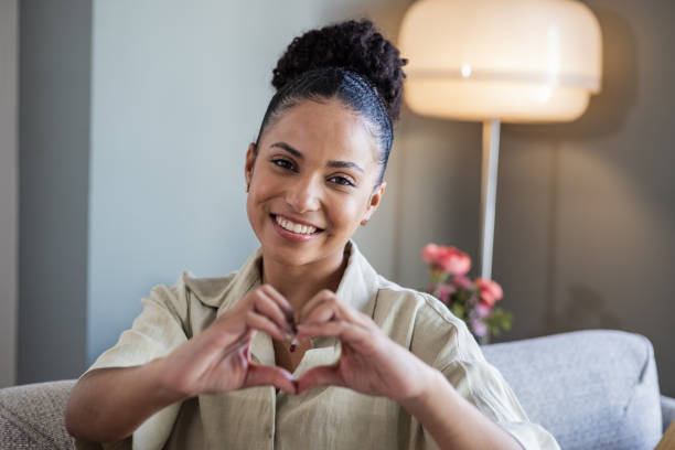 istock Smiling woman making heart shape with hands 1452569814