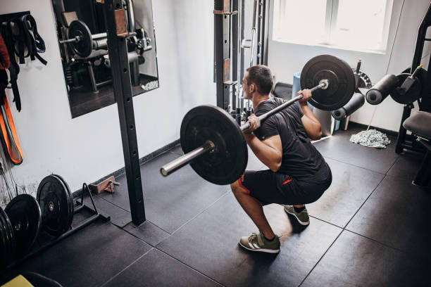 istock Young man weightlifting in gym 1452573665