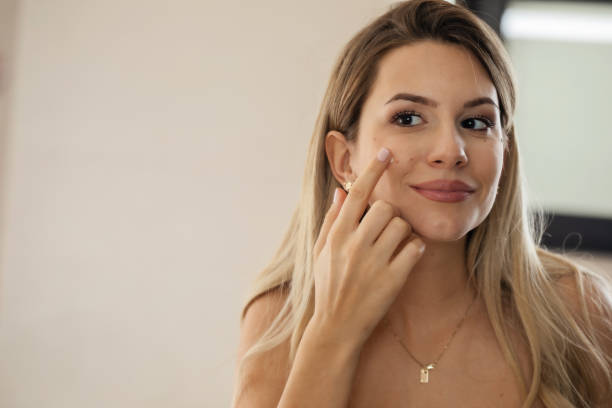 istock Woman Applying a Face Cream 1452576648