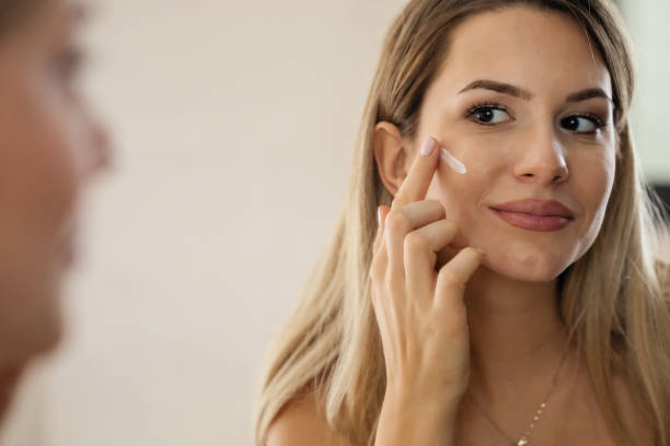 istock Woman Applying a Face Cream 1452576650