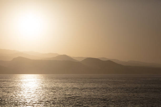 View to mountains in hazy atmosphere against the sun near Las Palmas, Gran Canaria, Spain