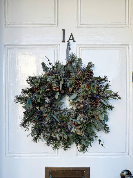 istock Christmas wreath on light grey door 1452577680