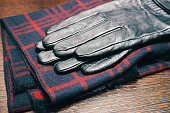 Men's leather gloves and a plaid scarf