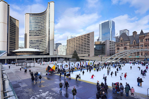 Toronto, Canada - December 26, 2022:  The free skating rink at City Hall square is a popular attraction, with skate rentals available.