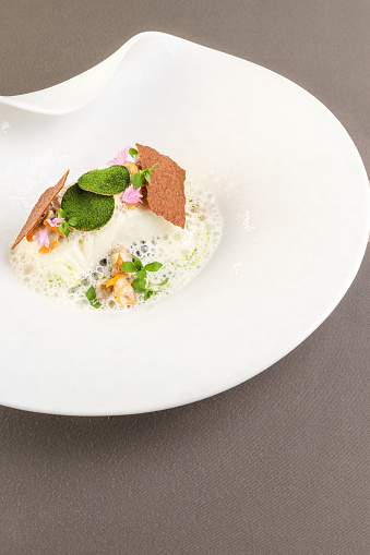 Michelin star gourmet fish fillet dish in creamy herb sauce