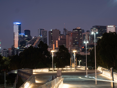 Looking at Melbourne skyline at night from elevated walkway
