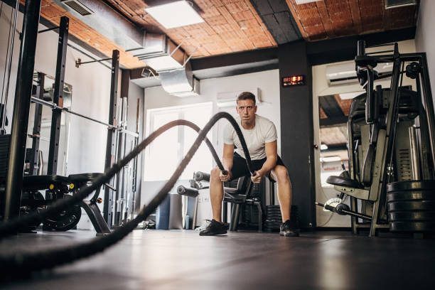 istock Man exercising with battle ropes 1452581980