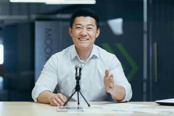 istock A young Asian man broadcasting his audio podcast using a microphone in his small TV studio 1452582089