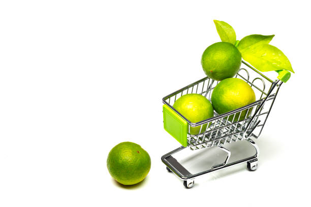 Lemmon fruits inside a miniature shopping trolley.Conceptual photo for buying healthy food in the supermarket.Image taken in studio with strobe lights