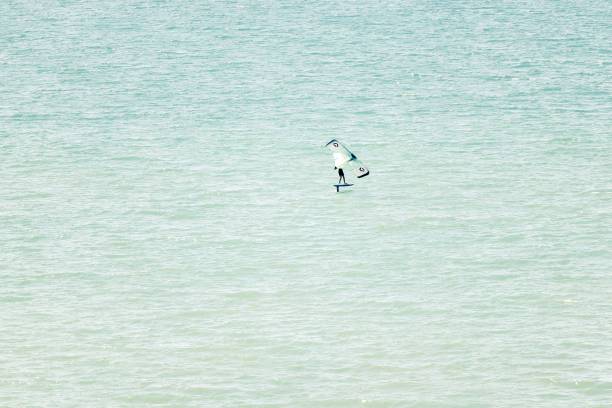 istock Person windsurfing on the tranquil turquoise seascape while on vacation on Canary Islands 1452586352